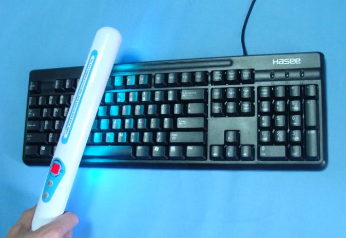 UV sterilization stick wand on keyboard