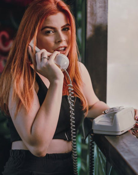 woman-using-landline-phone