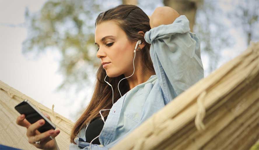 woman watching youtube with earbuds