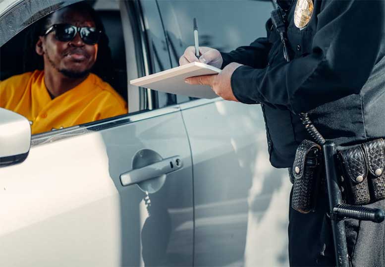 cop writing speeding ticket